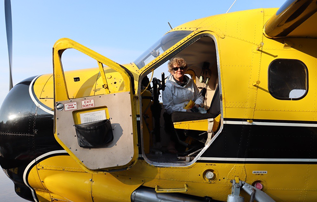 A person in a yellow airplane